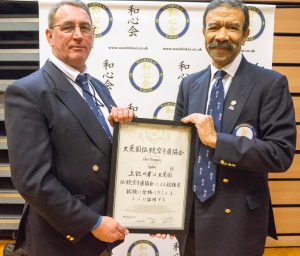 Neville Smith presenting Shihan Christopher Thompson his 9th Dan certificate.